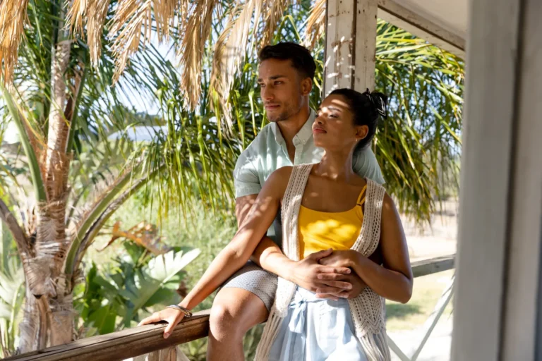 A couple on the balcony of an airbnb hotel somewhere in asia.