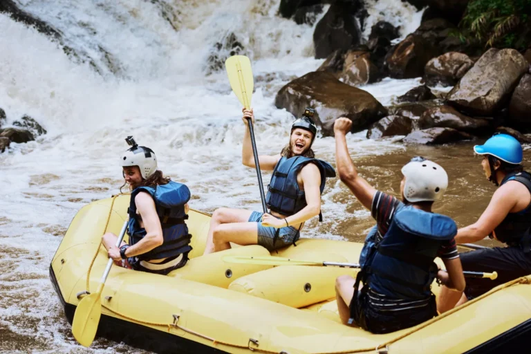 A group of friends canyoneering in the water.